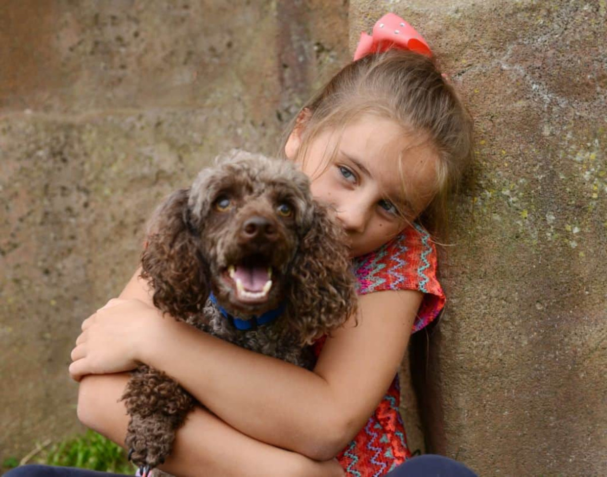 Child with pet dog