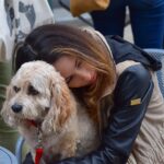 Woman cuddling dog on her lap