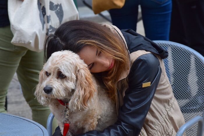 Woman cuddling dog on her lap