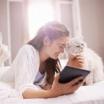 Woman stroking white cat