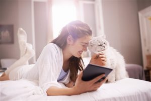 Woman stroking white cat