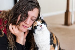 Woman cuddling cat