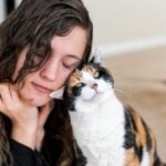 Woman cuddling cat