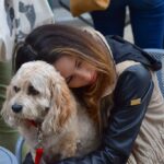 Woman cuddling a dog