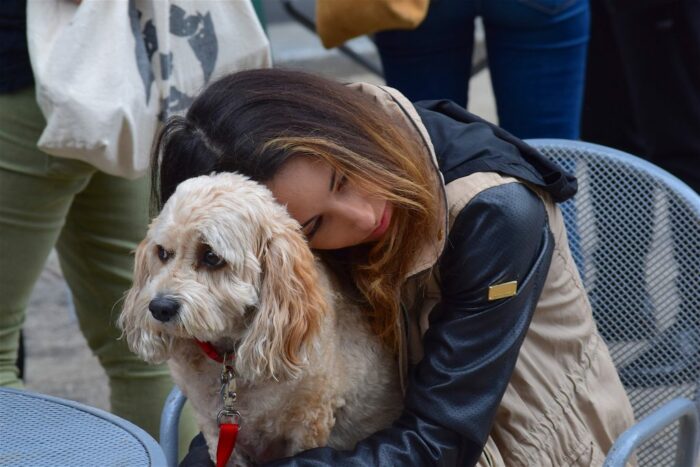 Woman cuddling a dog