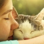 Girl kissing cat