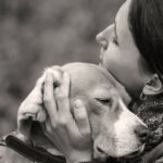 Woman cuddling dog