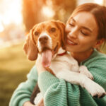 woman cuddling dog