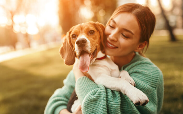 woman cuddling dog