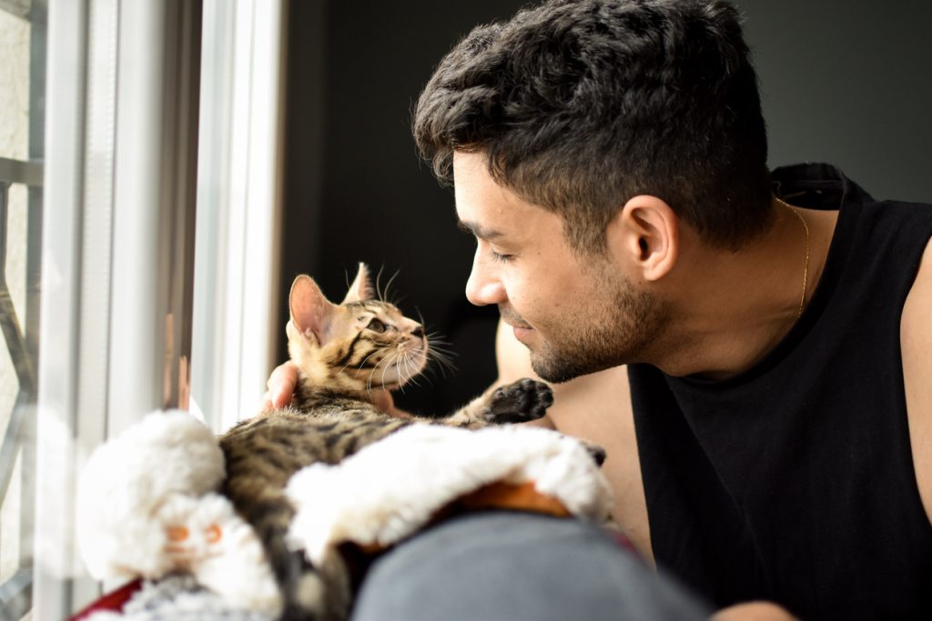 Man cuddling cat