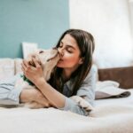 Woman kissing dog