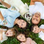 Family and dog laying on back