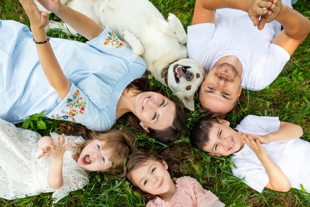 Family and dog laying on back