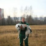 Man holding spotty dog