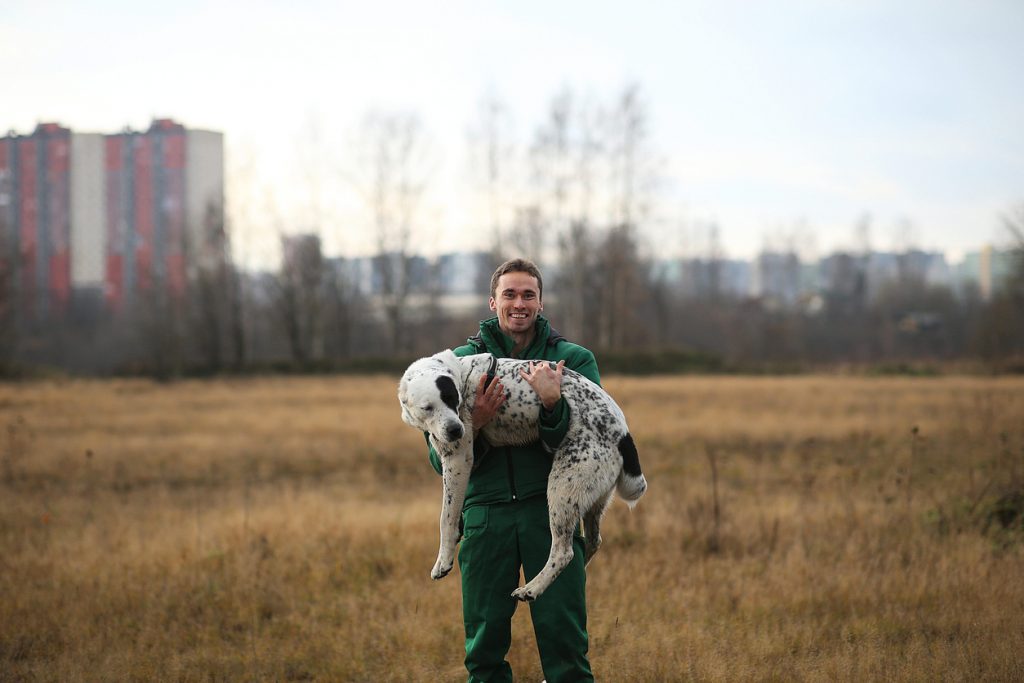 Man holding spotty dog