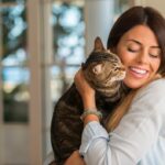 Woman cuddling cat