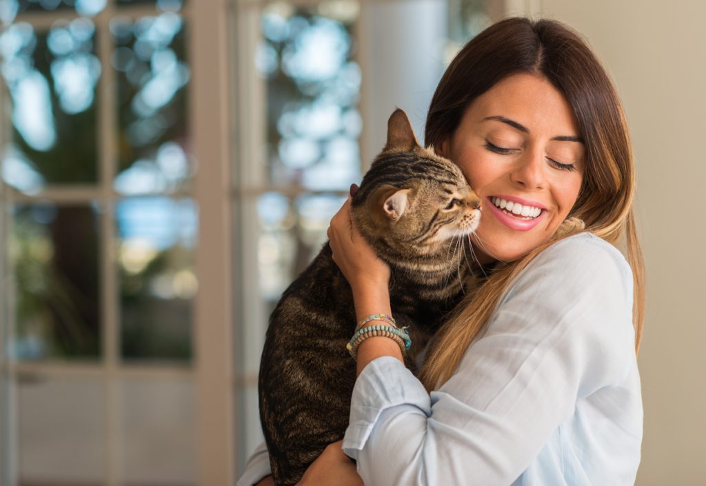 Woman cuddling cat