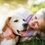 Woman cuddling dog