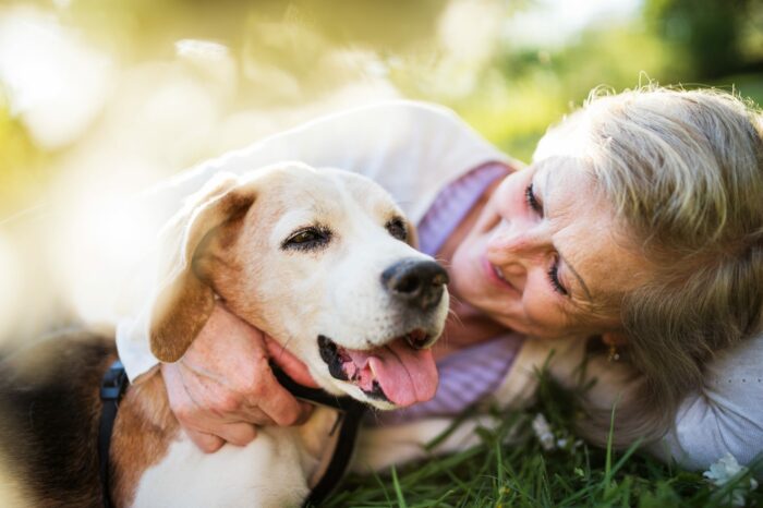 Woman cuddling dog