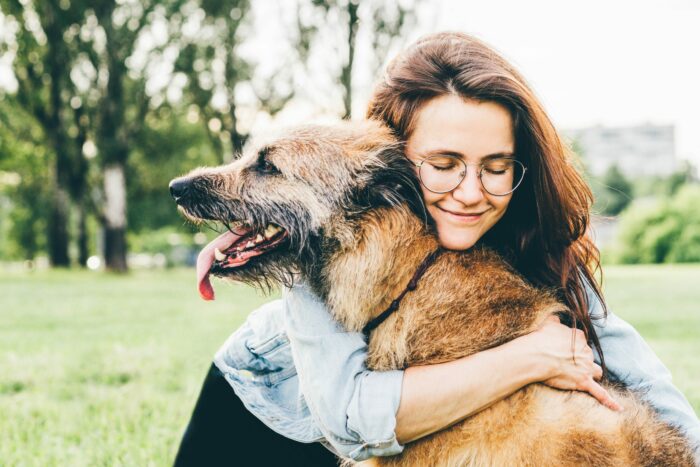 Woman cuddling dog